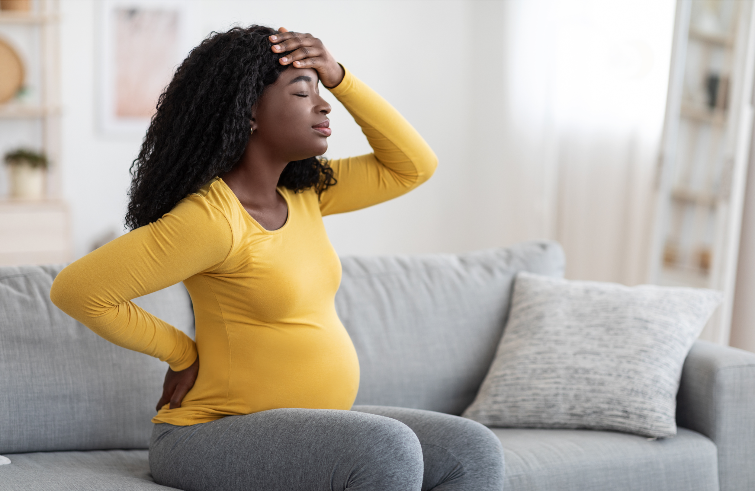 pregnant woman with low back pain and headache