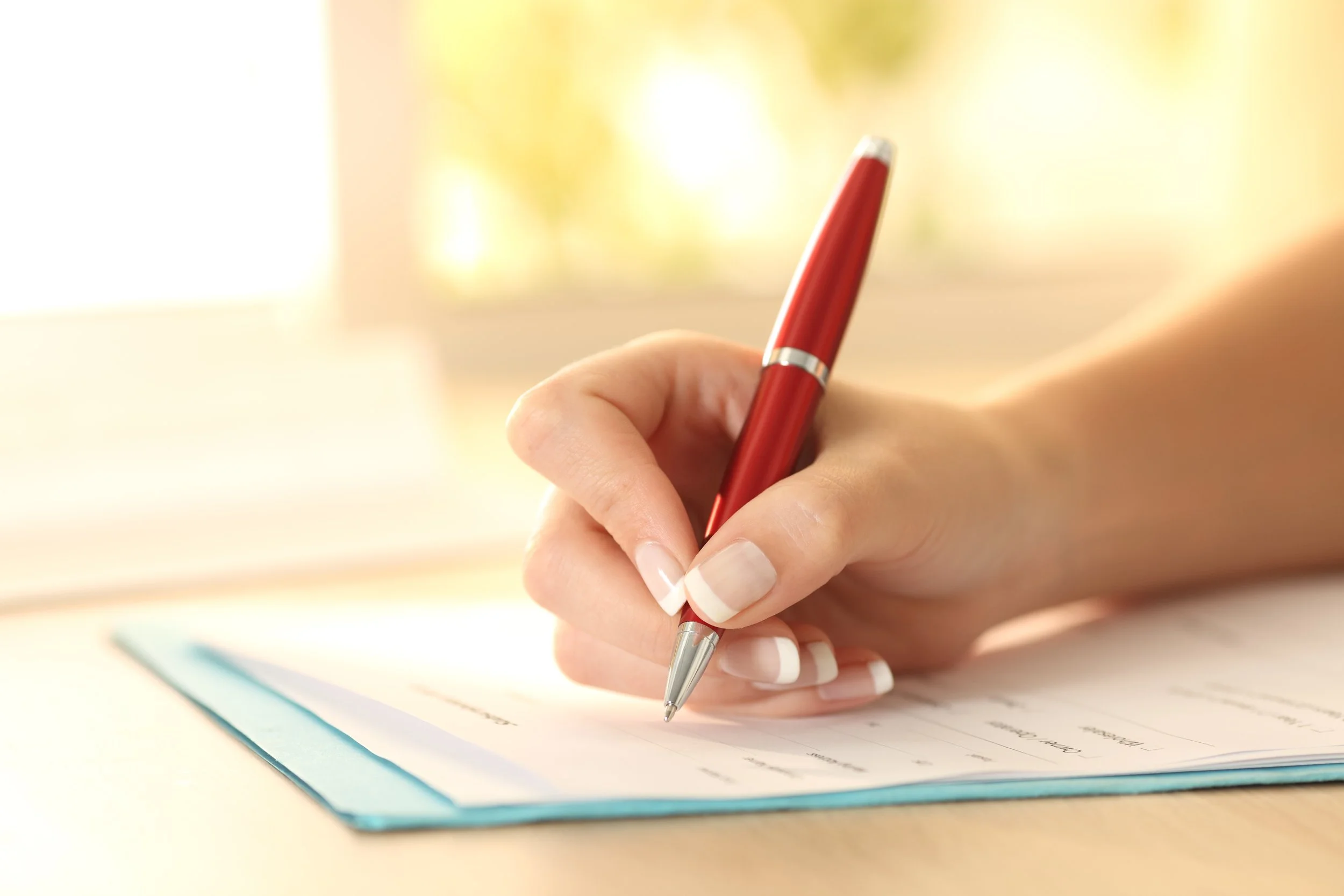 woman writing on a piece of paper