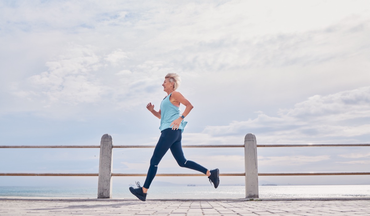 Female runner on a waterfront path